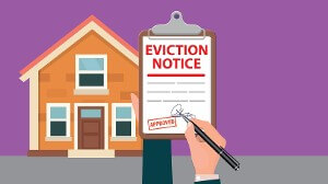 Eviction notice held up in front of house