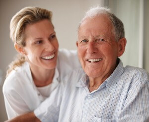 Daughter smiles with her elderly father