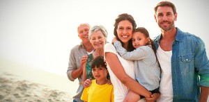 Multiple generation family pose for photo by the beachside