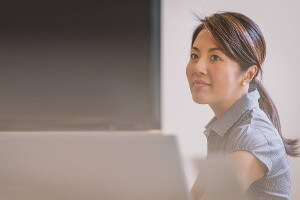 Business woman sits behind a computer